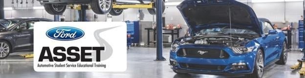 Ford ASSET automotive training facility with vehicles on lifts and a blue Ford Mustang with the hood open, showcasing a hands-on learning environment